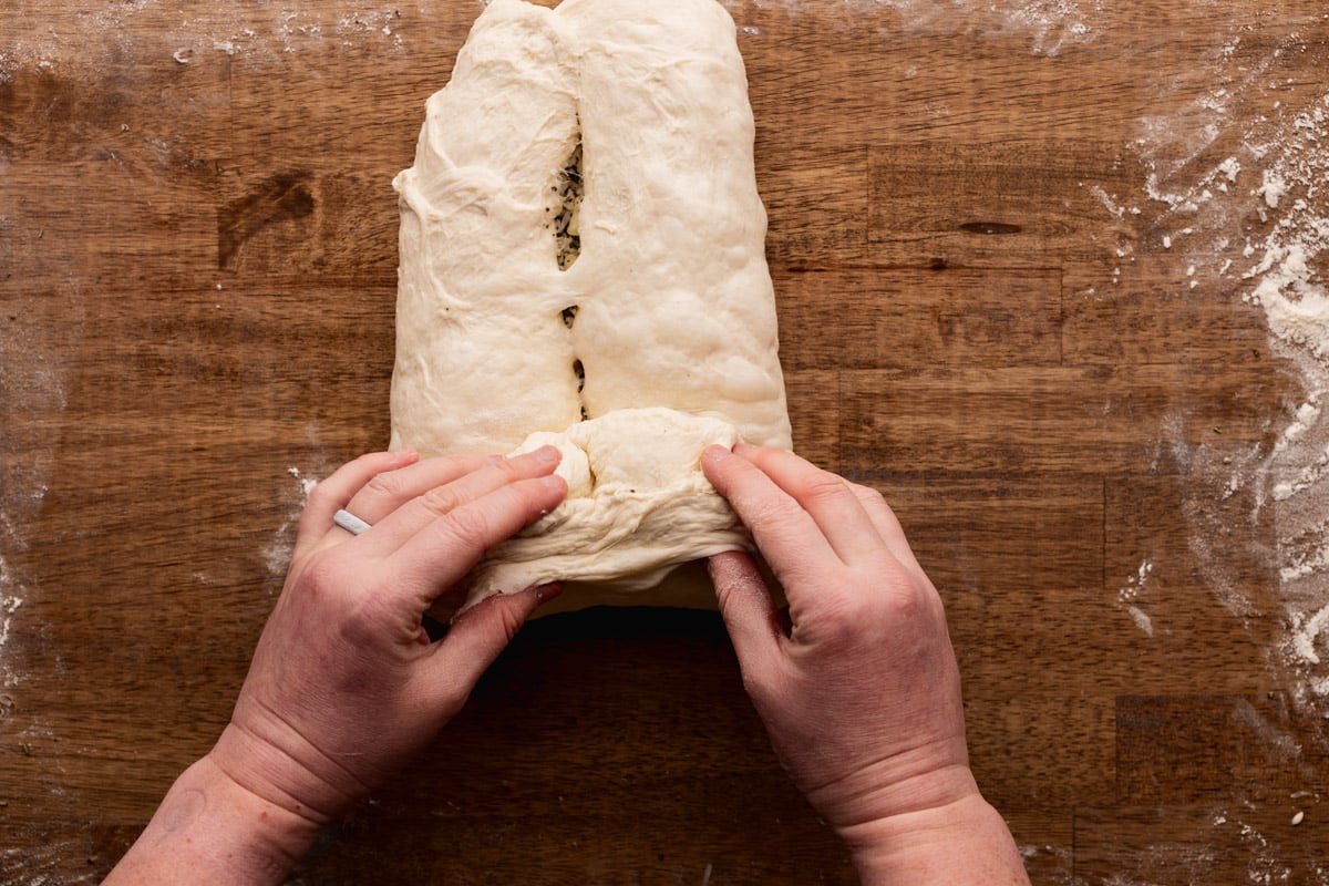 rolling bottom edge of sourdough loaf.