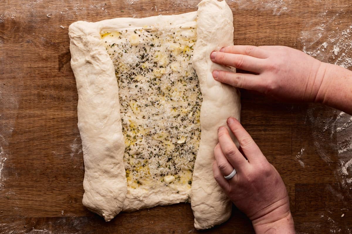 rolling right edge of sourdough rectangle into middle.