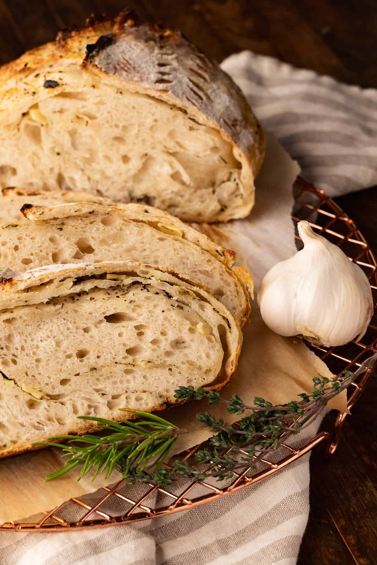 slices of garlic and herb sourdough bread on cooling rack.
