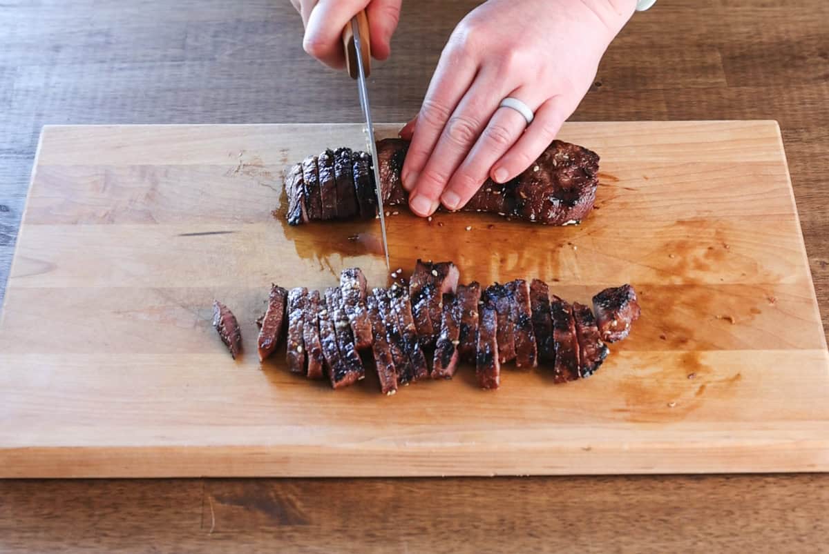 slicing grilled elk steak.